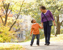 Cargar imagen en el visor de la galería, A joyful grandmother enjoys a park stroll with her grandson, made possible by the compact Inogen Rove 6. Its small, unobtrusive 4.8 lb design and Intelligent Delivery Technology allow for natural movement and easy conversation, proving that high-capacity oxygen support can be both powerful and conveniently portable.
