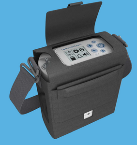 Inogen Rove 6 portable oxygen concentrator shown with standard single battery attached. Lightweight, FAA-approved pulse dose oxygen system designed for mobile use by seniors and oxygen patients. Features a sleek gray body with easy-to-read LCD display, simple push-button controls, and ergonomic carrying handle. The Rove 6 delivers pulse flow settings 1 through 6 using Intelligent Delivery Technology™, ensuring reliable oxygen delivery during rest, activity, and sleep. Ideal for travel, daily errands, or at-